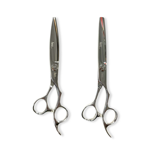 Pair of silver scissors on a white background